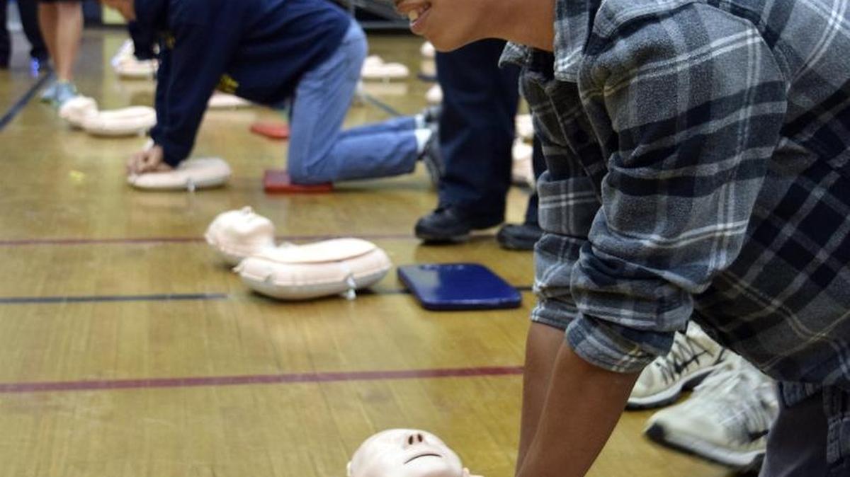Sixth- through eighth-graders at Ross Middle School in Hughson were taught compression-only CPR during P.E. classes May 2. Here, eighth-grader Alan Candido competes with seventh-grader Keegan McFadon (in blue hoodie) and sixth-grader Briannah McNertney (barely visible in background) after instruction.