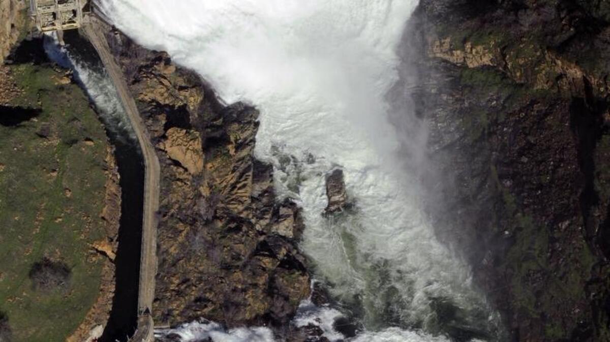 Water runs over La Grange Dam after a series of storms in 2010