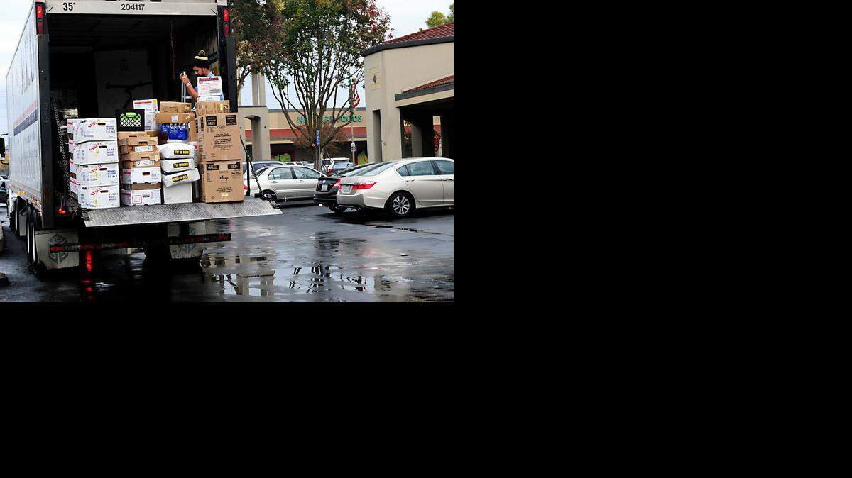 
Aaron Colon, a delivery driver with Sysco, prepares his load on Wednesday morning (11-19-14) in the rainy weather at McHenry Village in Modesto, CA. Despite the wet pavement, the Modesto Irrigation District’s downtown station reported no measurable rain by late Wednesday afternoon.
