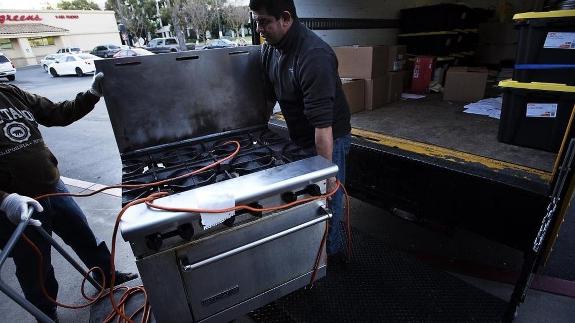Victor Mezquita and other members of a crew remove equipment Wednesday from the Chevys Fresh Mex restaurant at Standiford Avenue and Carver Road in Modesto, which has closed.