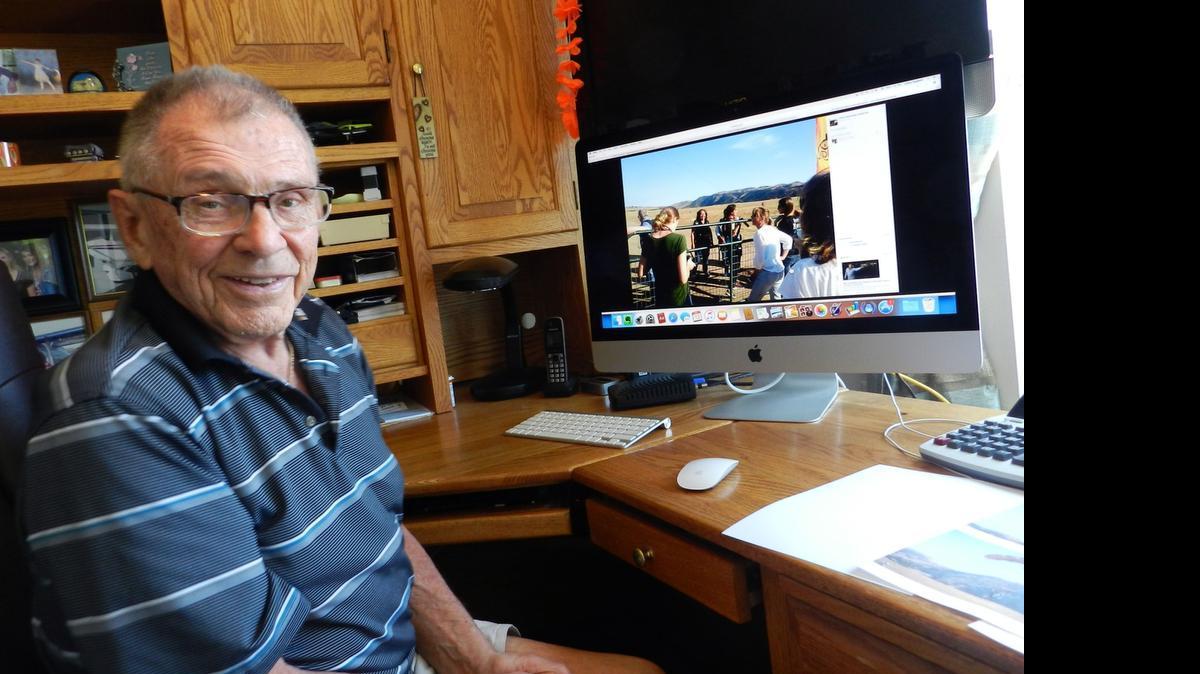
In the office of his home at Dale Commons on Monday, LeRoy Nygaard looks at photographs from his 85th birthday sky-diving trip to Hollister with friends and family on Saturday.
