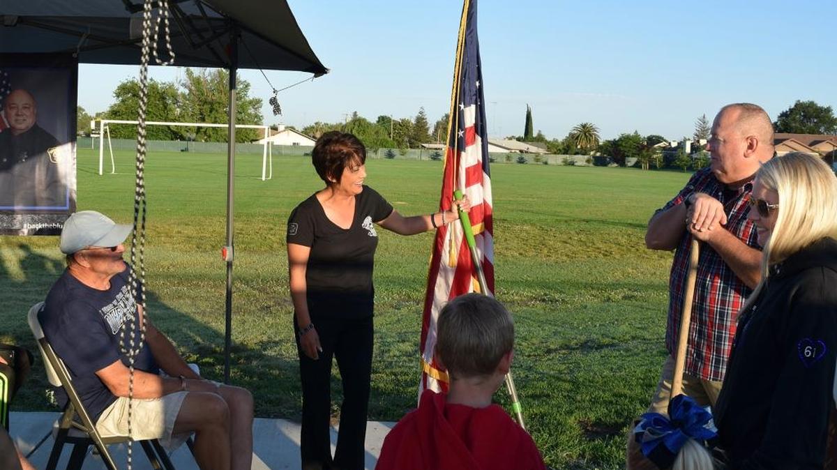 Mercedes Wallace (center) shares a light moment with Dave Wallace (right). Friends and family gathered this morning (06-06-17) at the Hughson Sports and Fitness Complex for a groundbreaking on the memorial garden for fallen Stanislaus County deputy Dennis Wallace who was killed in the line of duty in November of 2016.