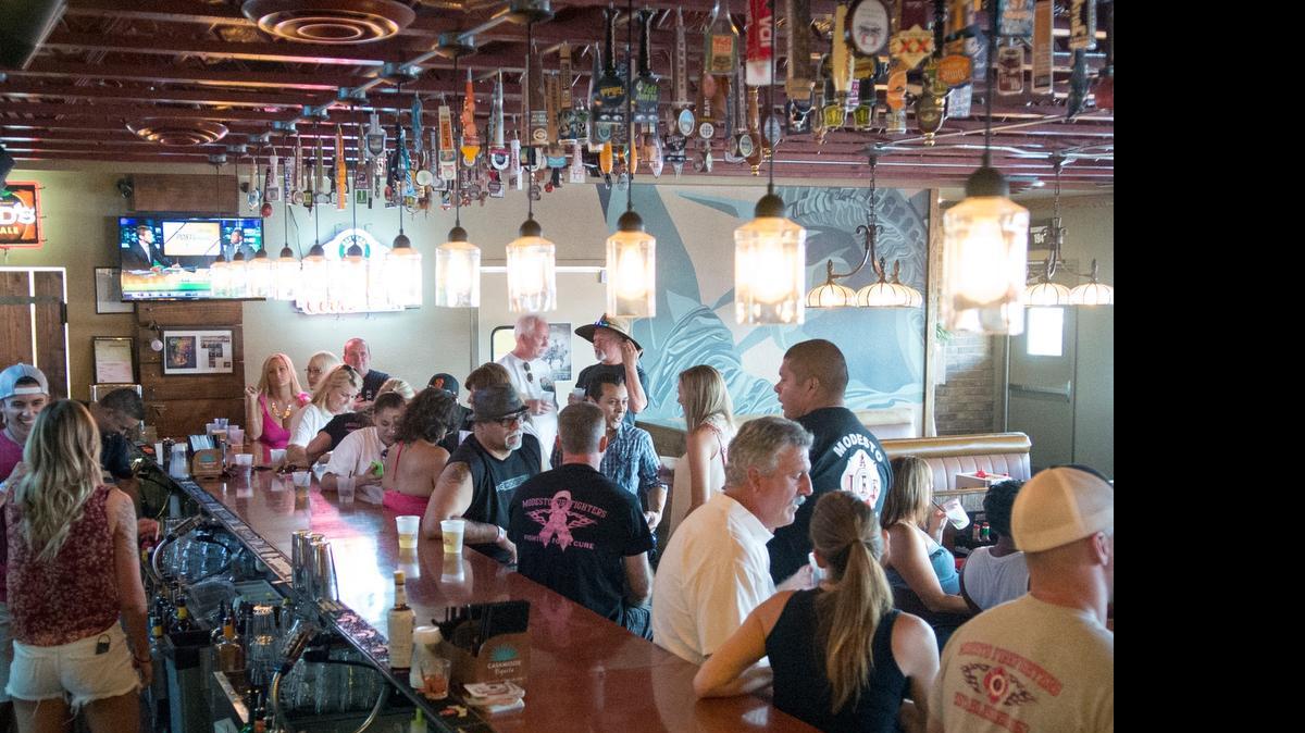
Business at the bar is lively during the Round Up, a fundraiser to benefit the Modesto Fire Association’s Widows and Orphans fund, on Saturday at Rivets American Grill in Modesto.
