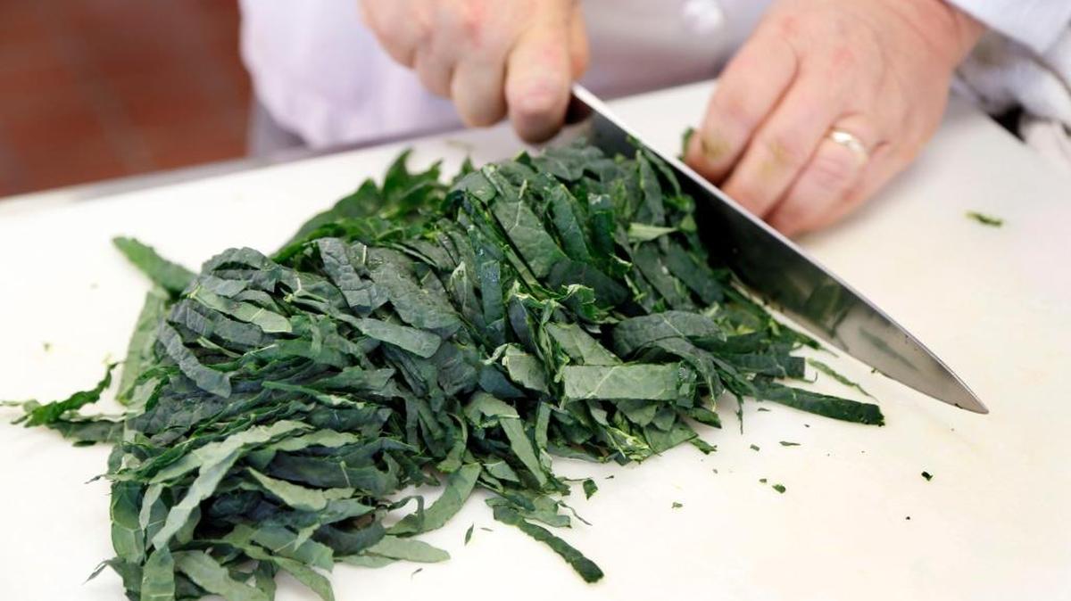 Chef Bob Perry slices lacinato kale into ribbons in a food lab kitchen at the University of Kentucky on Jan. 7, 2016, in Lexington, Ky. The battle to get picky children to eat enough vegetables seems never-ending to some parents.