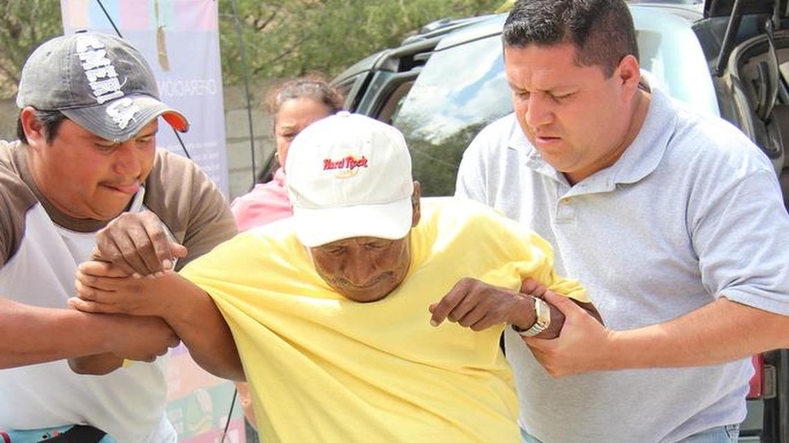 A man who lost both legs is seated in the wheelchair given to him during a mission trip to Mexico in October.