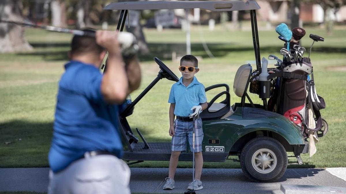 
Kohen Ficher, 6, of Turlock watches as his father, Joel, tees off at Modesto Municipal Golf Course in Modesto on Saturday, Sept. 26, 2015. Modesto officials will discuss Monday whether to close the course.
