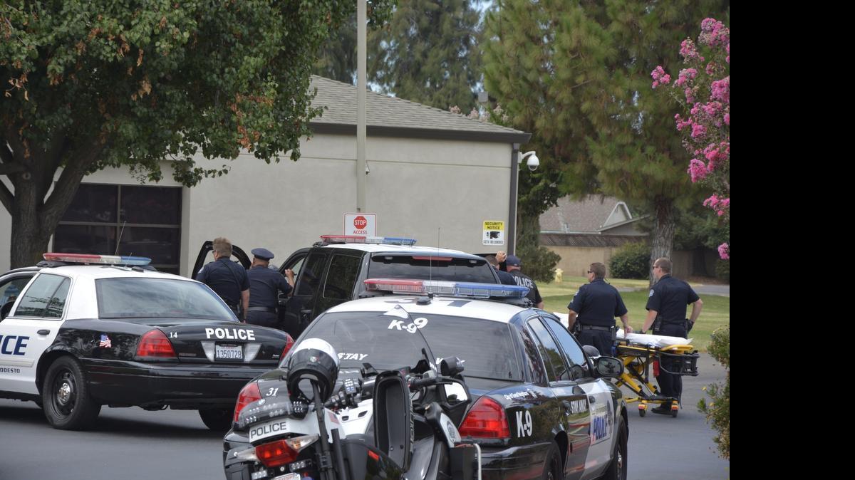 
Police are seen at Doctors Behavior Health Center at Briggsmore Avenue and Claus Road. At 9:55 a.m. Saturday a woman was seen on the lawn outside the center holding a knife to herself, and police spent nearly six hours negotiating with her before the standoff ended and she was take for medical evaluation.
