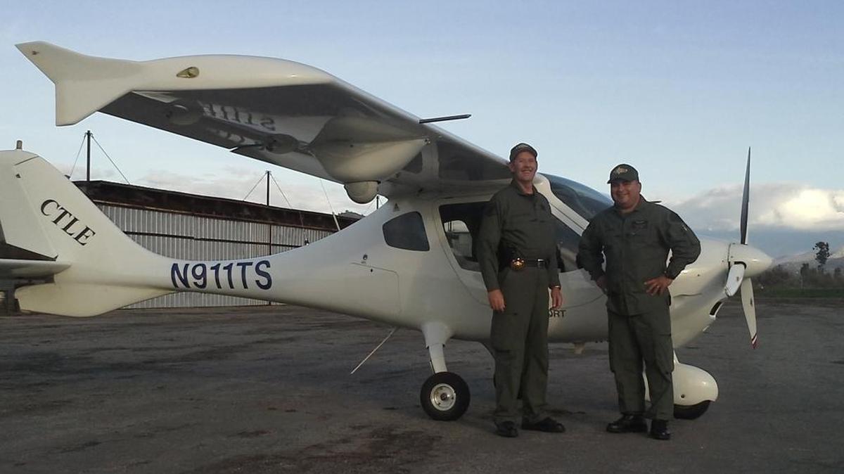 Sheriff’s Deputy Scott Ballantyne and sheriff’s Pilot James Chavez pose for a photo with Sheriff One. The two men were killed Feb. 10 when this light sport aircraft crashed into the side of a mountain along Highway 190.