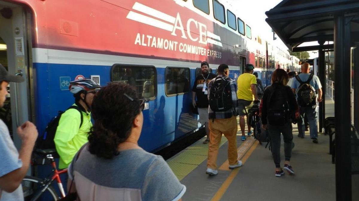Riders disembark from an Altamont Corridor Express train at a station serving Lathrop and Manteca in September.