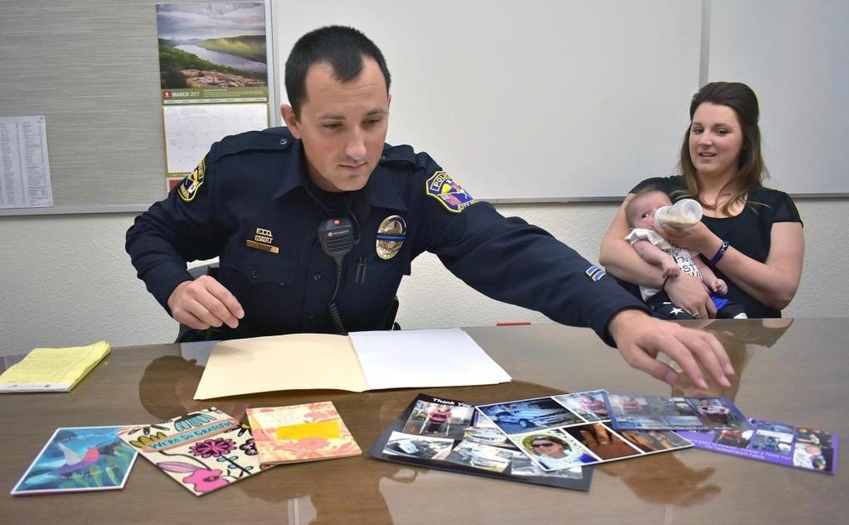 Each year around the anniversary of a rollover crash she survived, Megann Scott has visited Turlock police Officer Joe Dusel to thank him for citing her for a seat-belt violation just days before the crash. Had she not been ticketed, she wouldn’t have begun buckling up and likely would have died in the crash, she said. Here, in 2017,Dusel lays out cards and photos the family has given him.