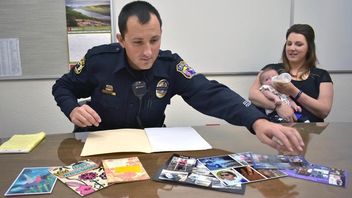 Each year around the anniversary of a rollover crash she survived, Megann Scott has visited Turlock police Officer Joe Dusel to thank him for citing her for a seat-belt violation just days before the crash. Had she not been ticketed, she wouldn’t have begun buckling up and likely would have died in the crash, she said. Here, Dusel lays out cards and photos the family has given him.