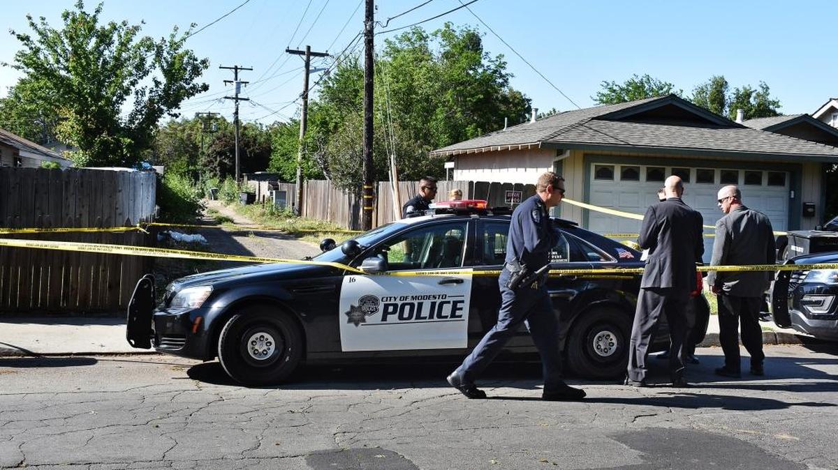 Modesto police work the scene in an alley off Evergreen Avenue near Carver Road where the nude body of a woman was found Friday morning, April 21, 2017.