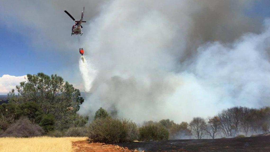 Calfire battles a wildfire near Jamestown, Calif., on Saturday, July 29, 2017.