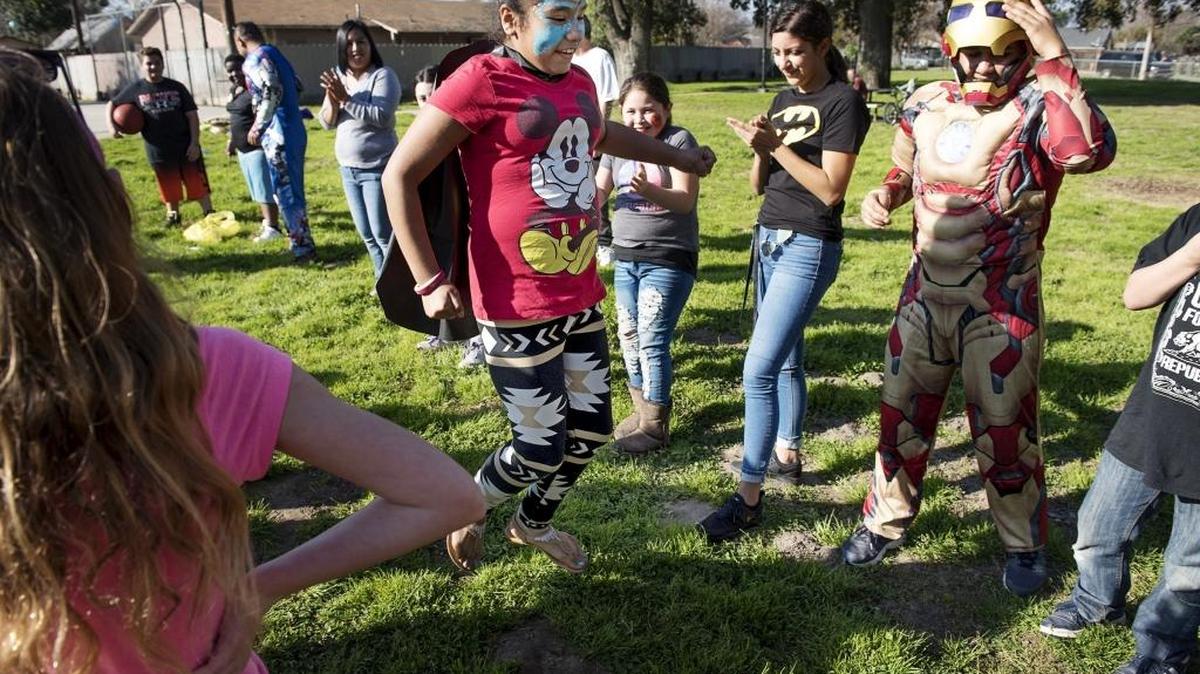 Guadalupe Madrid, 11, participates in a group game during the Police Athletic League's event "Heroes in the Park" at Oregon Park in Modesto on Saturday, Feb. 3, 2018.