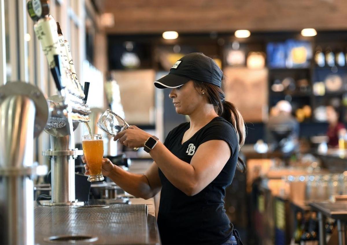 Bartender Mykeya Johnson pours draft beer on Thursday (05-18-17) at Dust Bowl Brewing in Turlock, Calif.
