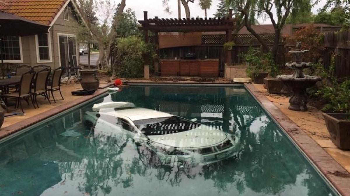 A car crashed through a fence and ended up in a swimming pool at a home on Olive Grove Court in Riverbank early Sunday.