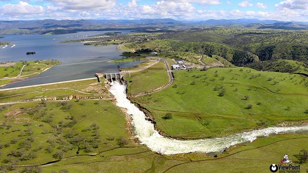 The Don Pedro spillway is seen from the air Feb. 22 while the gates were open to lower the brimming reservoir. MID and TID would like to release even more water down the swollen Tuolumne River, but federal officials have prevented that because of concerns about the strain on levees downstream.