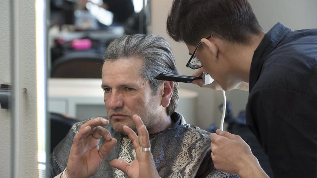 Raymond Odisho, right, gives homeless resident Martin Sandoval a haircut at the Erin Milan Salon & Spa in Modesto, Calif., on Tuesday, March 8, 2016.