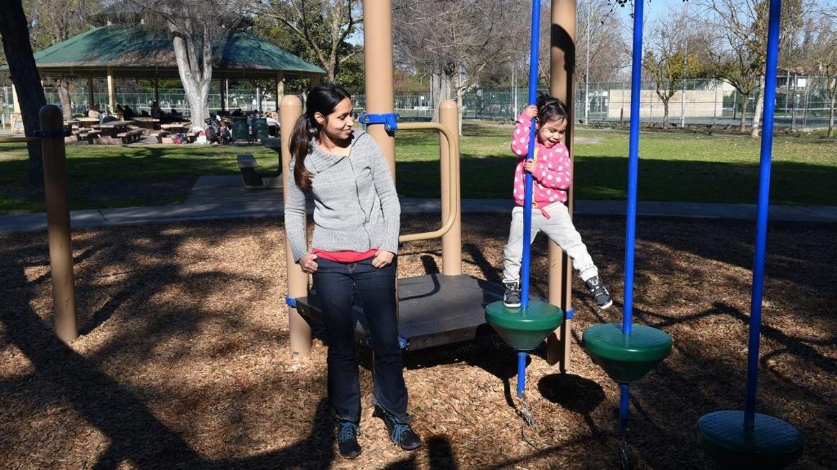 Pari Patino, 3, of Modesto uses the play structure on Friday at Graceada Park in Modesto with her mother, Nav. Work has begun on installing four surveillance cameras at the park.