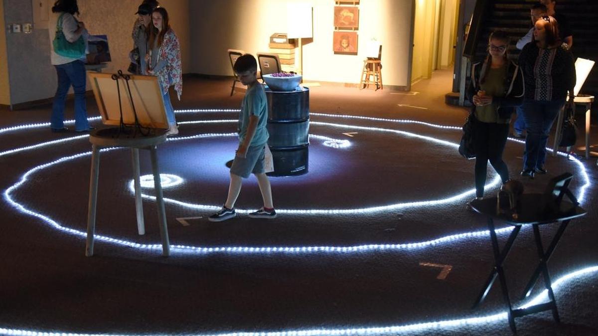 People walk through the artistic “Road To The Cross” at the Redeemer Church of Modesto.