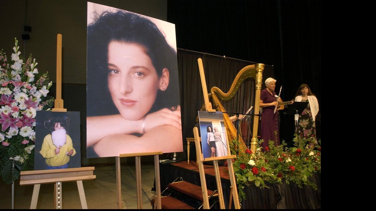 
In this May 28, 2002, photo taken at Modesto Centre Plaza, photos of Chandra Levy are on display as musicians stand by at the memorial service for Levy. 
