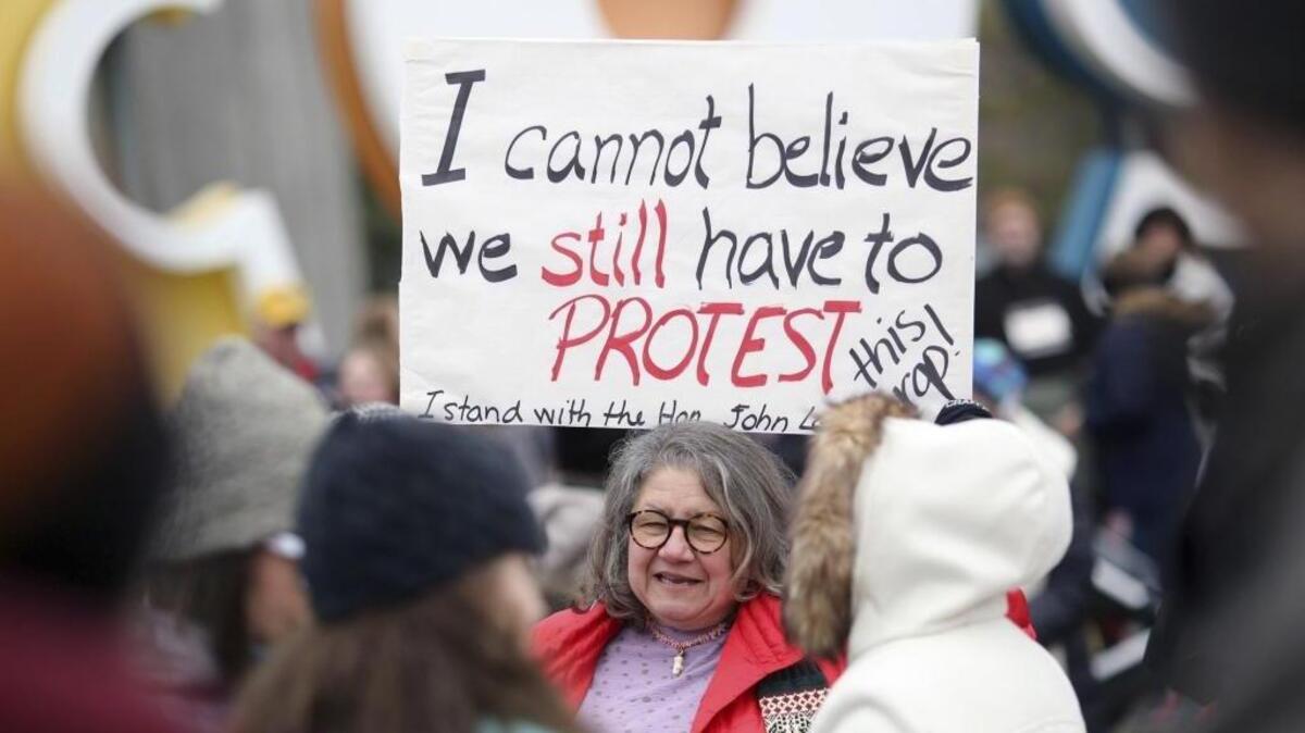 On Sunday at the Columbus, Ohio, sister march to the upcoming Women’s March on Washington, Diana Angus holds a sign she made at home.