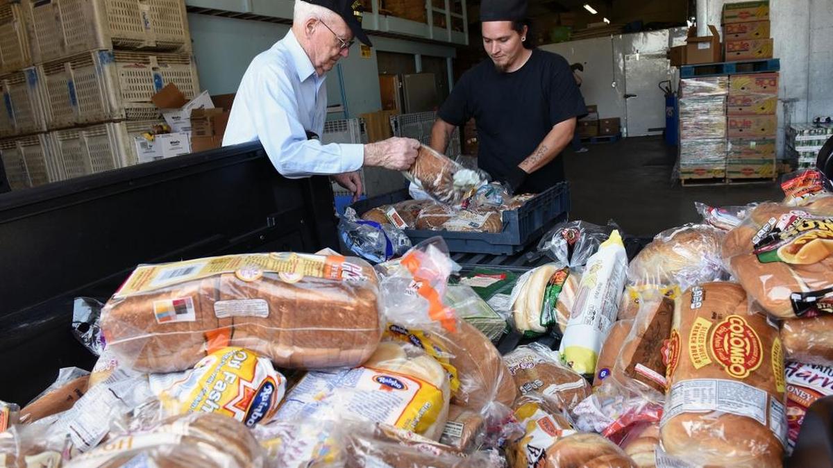 Volunteer Eugene Mould, left, and warehouse leader Manuel Romero unload donated bread Tuesday afternoon, April 19, 2016, at Inter-Faith Ministries in Modesto. Inter-Faith Ministries will have a project in the upcoming Love Modesto Community event. They are asking for volunteers to pick up donated food from people in various neighborhoods around town.