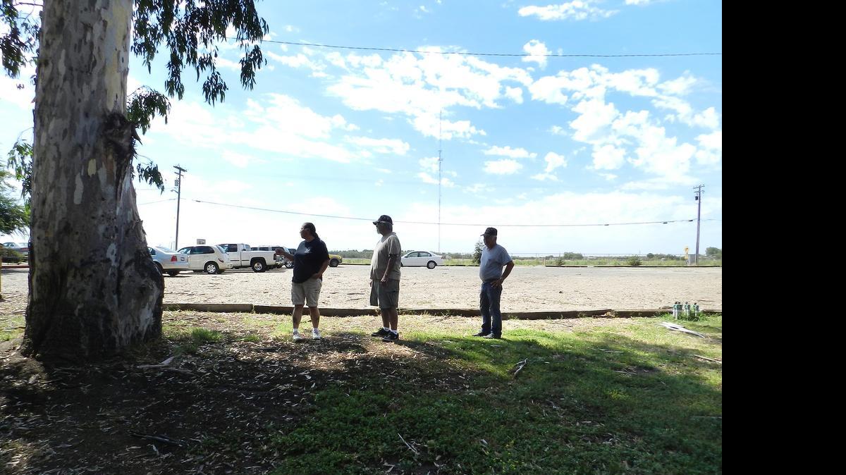 
Pat Rosales, Joe Anchondo and Al Pound stand between the parking lot and an area on which a playground will be built at VFW Post 3199.
