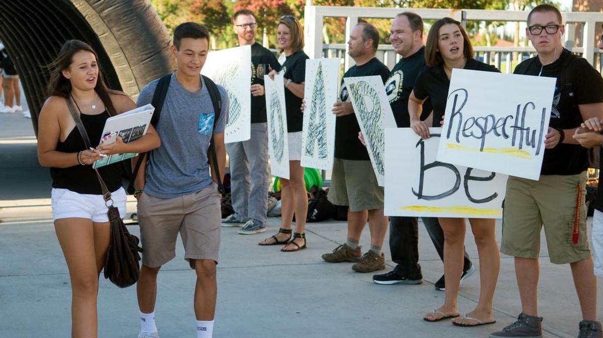 
Dana and Brandon West walk by the Be Respectful signs during the first day of school at Enochs High School in Modesto on Monday August 10, 2015.
