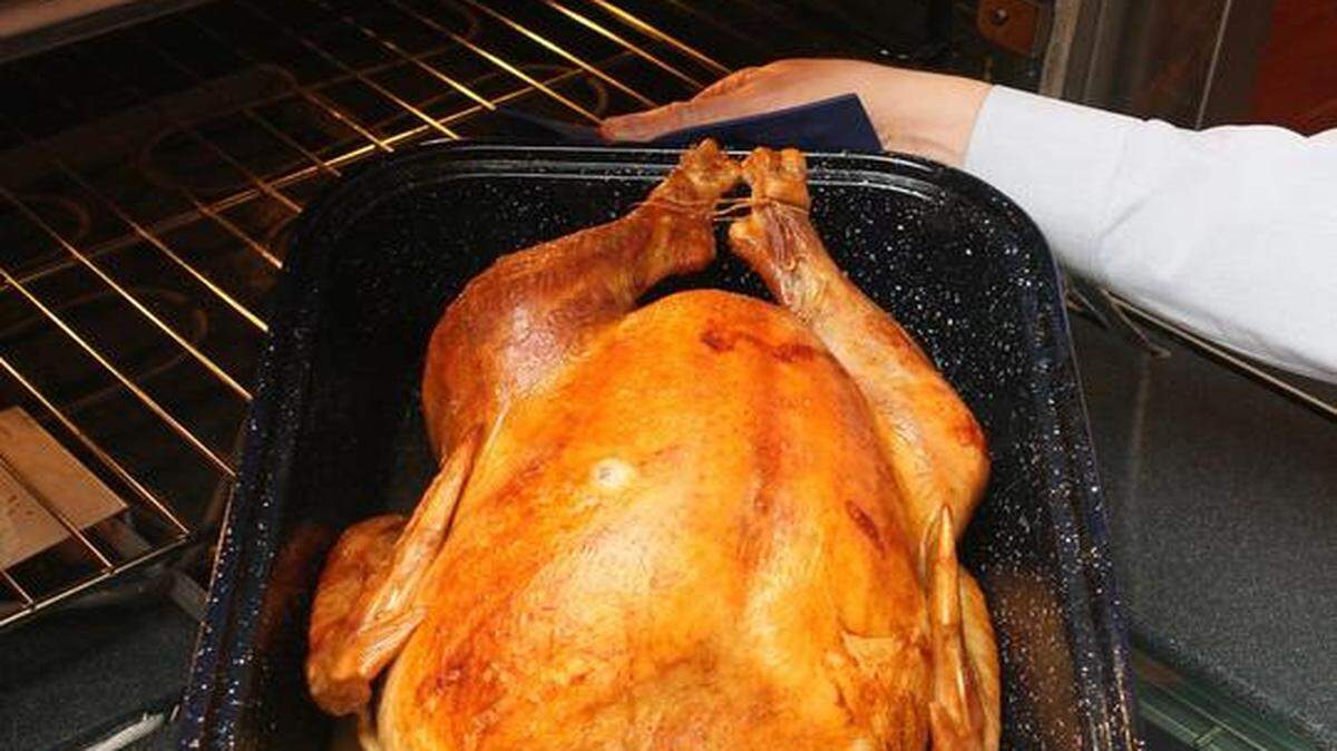 
Cook a turkey until a meat thermometer reads 180 to 185 degrees at the thigh, 170 to 175 degrees at the breast, and 165 degrees at the center of the stuffing.
