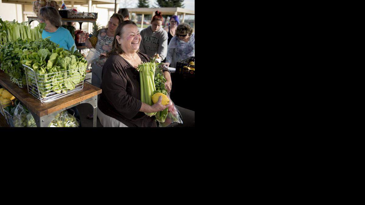 
Ruby Walls picks up groceries during Inter-Faith Ministries’ Neighborhood Free Mobile Farmers Market at Aspire Vanguard College Preparatory Academy in Empire on Wednesday. Inter-Faith is providing produce and other food free of charge in locations around Modesto.
