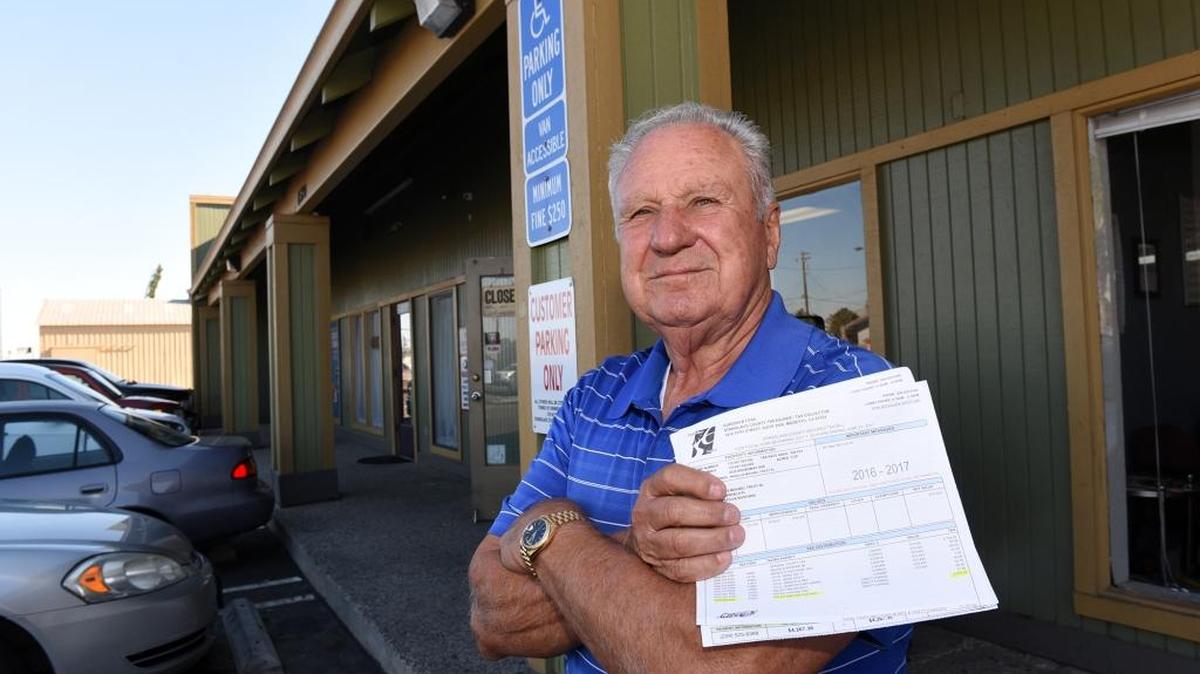 Mike Masellis is pictured with his Stanislaus County property tax bill Thursday outside the strip of buildings he owns in Salida. The sewer charges for La Hacienda restaurant, one of the businesses that is a tenant in his building on Broadway Avenue, shot up $6,500 this year.