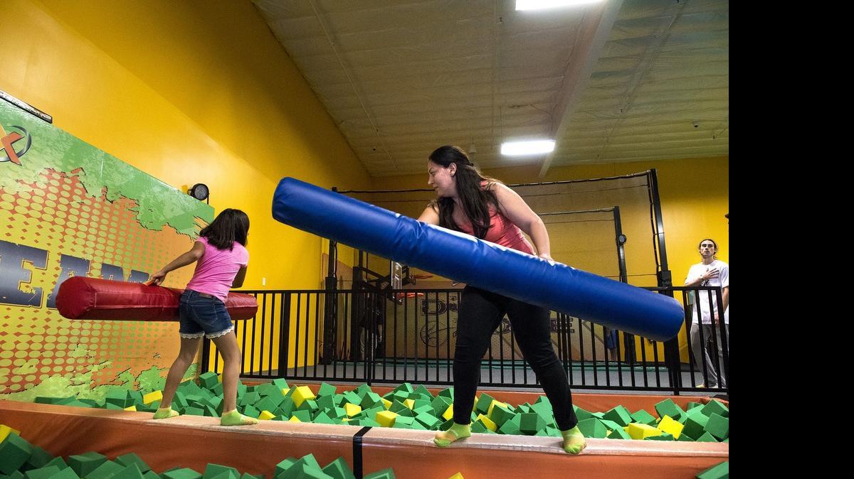 
Anita Ovrahim plays with her daughter Melanie, 10, on the X-Beam at Rockin’ Jump in Modesto, Calif., on Wednesday, May 6, 2015.
