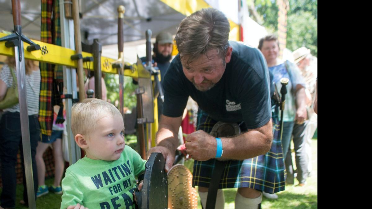 
Brook Weir, right, helps James Bunning IV wear a shield during the Scottish Highland Games at Tuolumne River Regional Park in Modesto on Saturday. Tartan was de rigueur on Saturday at Tuolumne River Regional Park as the 34th annual Modesto Scottish Highland Games and Celtic Festival reigned. Presented by St. Andrew’s Society of Modesto, the family festival fetes all things Celtic, with nods to the Scottish, Irish, Cornish, Norwegian and Welsh cultures, and features athletic events, bagpipers, Celtic music, children’s games, dancing and more.

