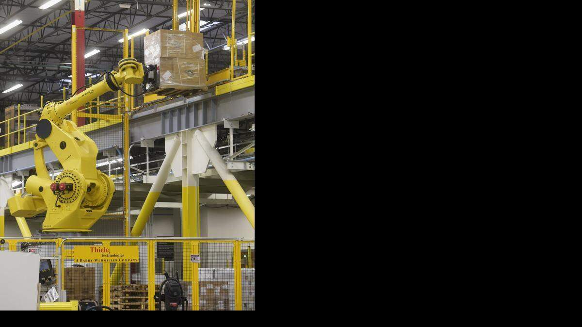 
The “Armazon” lifts packages on pallets from the lower floor to the upper floor during a tour at the Amazon fulfillment center in Patterson, Jan. 20, 2015, to demonstrate innovations used on a daily basis.
