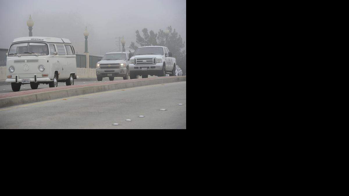 
Cars drive in the fog on the Kansas-Needham overpass in Modesto on Thursday afternoon.
