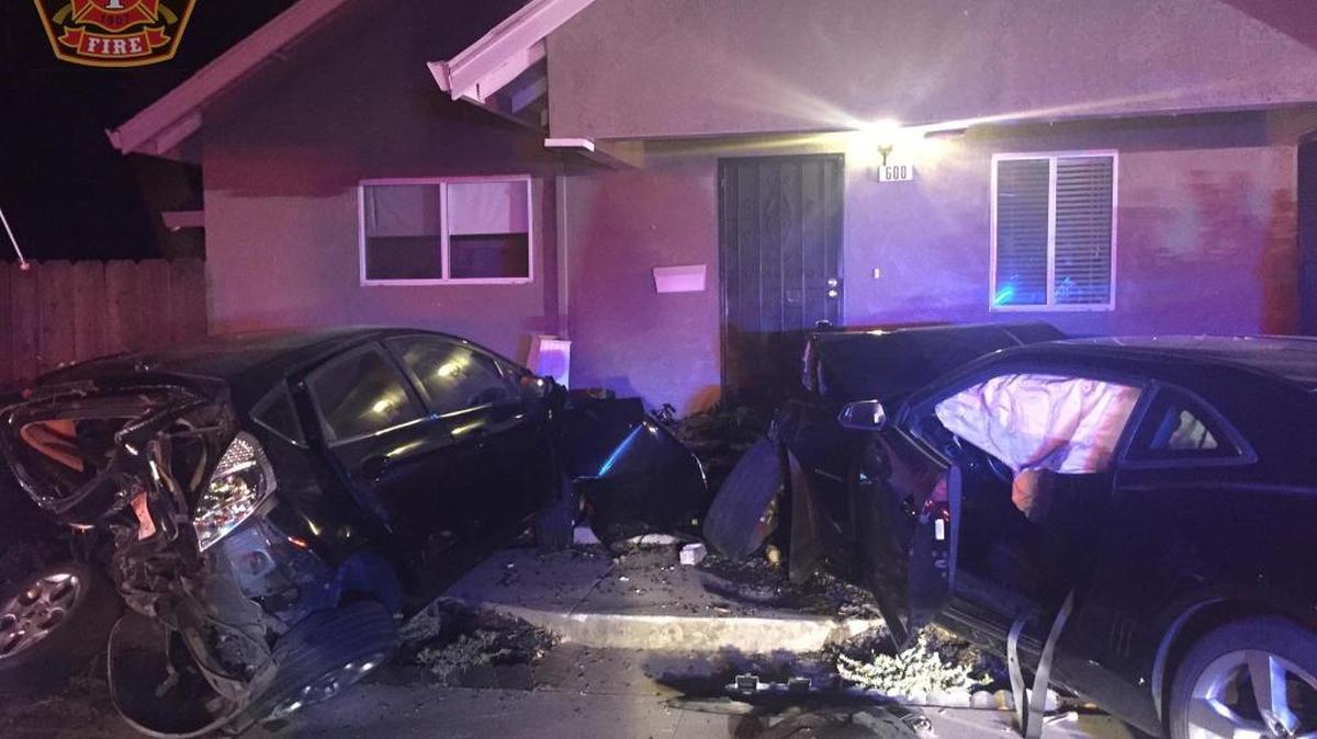 A car crashed into two parked vehicles, knocking down support beams for a porch at a home on East Linwood Avenue in Turlock, California on Sunday (July 17, 2017).