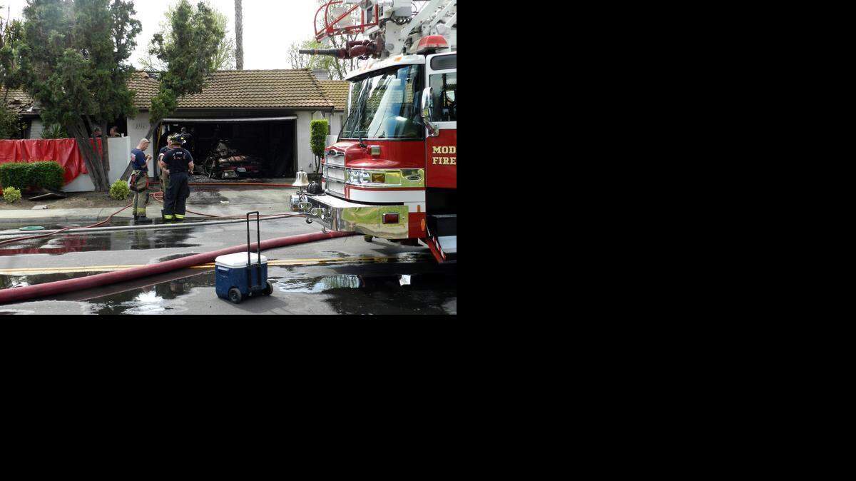 
Modesto firefighters mop up after a house fire in the 2700 block of El Pasado Drive that killed the owner. Theodore Burchette, 60, reportedly died of smoke inhalation. The cause of the blaze remains under investigation.
