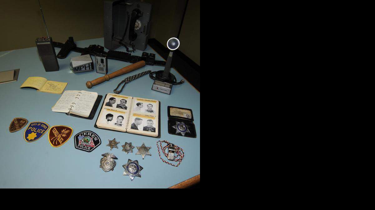 
A call box, radio, mug shot book, billy club, stars and badges are among the items of memorabilia collected by Officer Jason Coley of the Ceres Police Department. 
