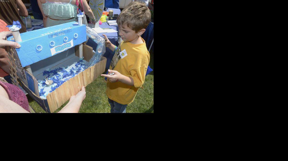 
Christopher Riddle talks about his water slide made out of recycled materials the Earth Day festival last year at Graceada Park in Modesto.
