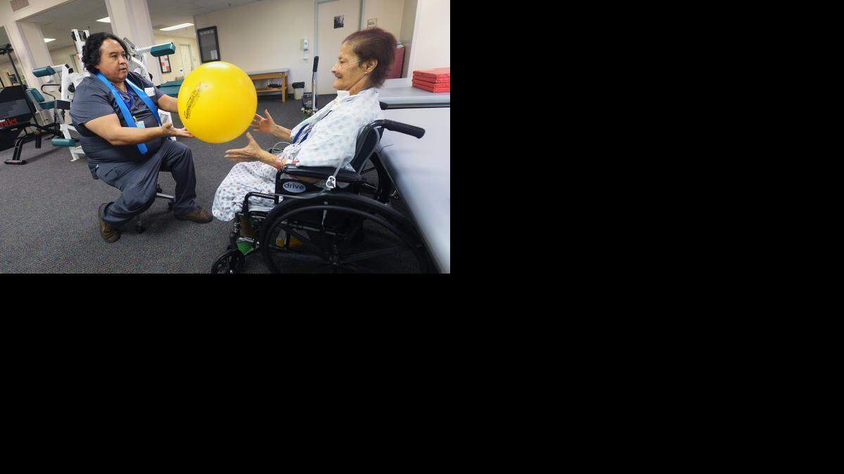 
John Cardoza, physical therapy assistant, works with Mary Dover of Turlock on her first day of physical therapy at Central Valley Specialty Hospital in Modesto.
