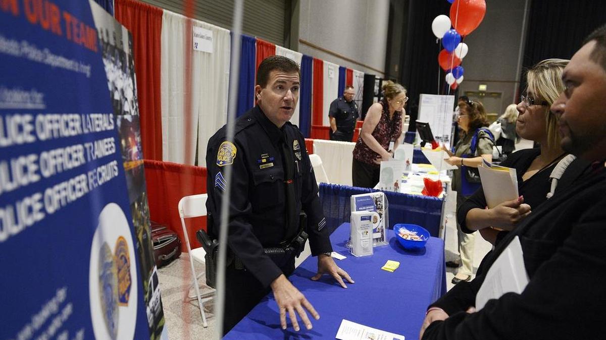 
Modesto police Sgt. Steve Stanfield talks with Turlock residents Hermila Espino and Francisco Vargas during the 2013 Central Valley Job Fair. This year’s fair will be Thursday at the SOS Club in Modesto.
