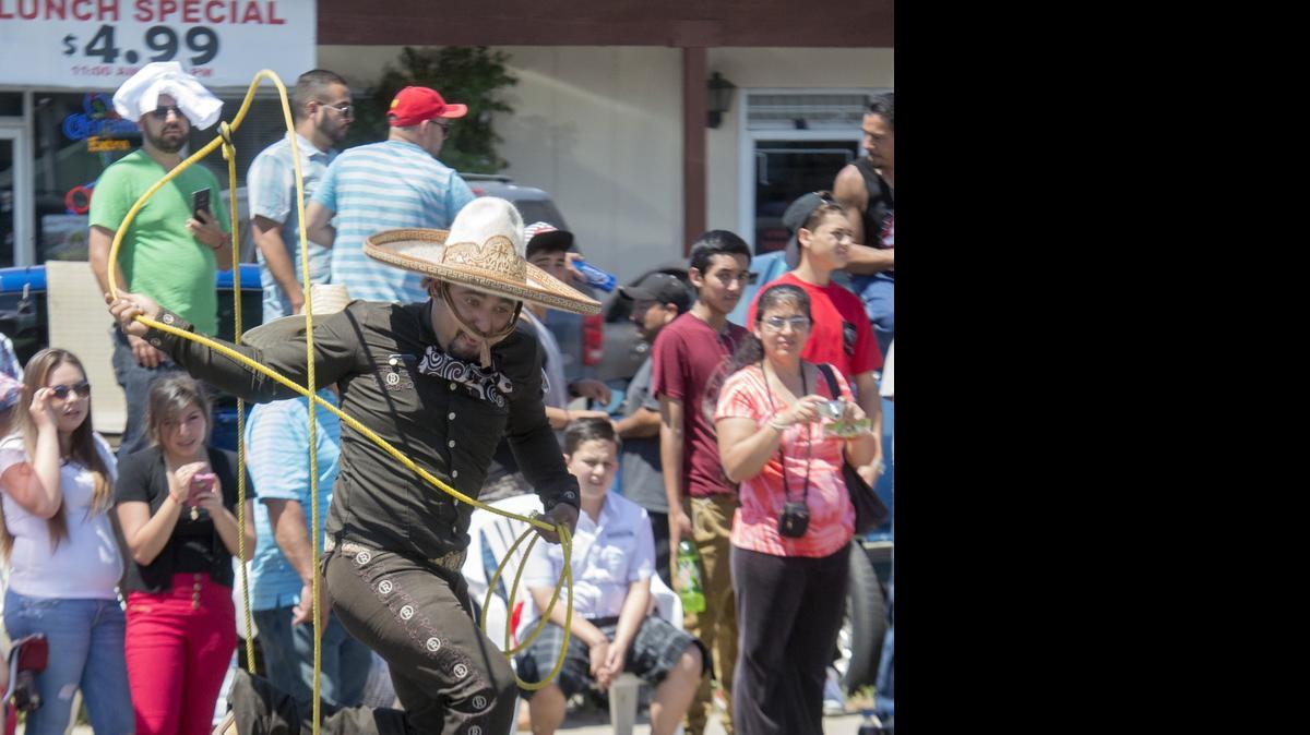 
Rafael Sanchez jumps through a rope during the Cinco de Mayo parade in Modesto on Crows Landing Road on Saturday.
