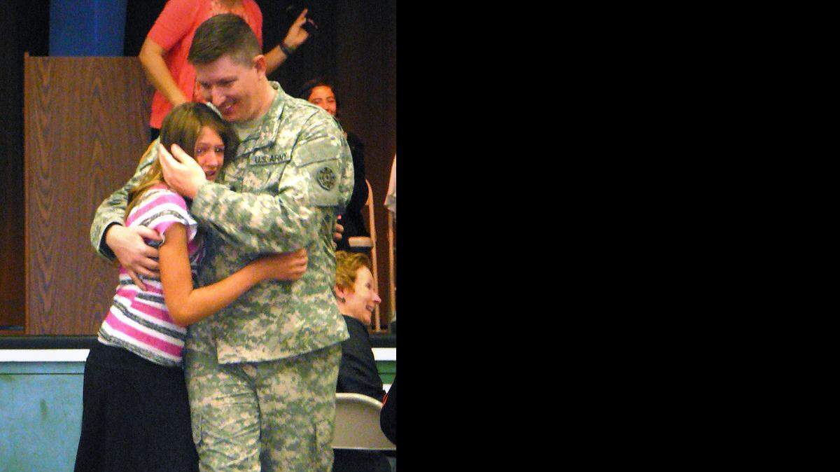 
 Army Sgt. Gary Helms surprises his daughter, Kaili Helms, at Somerset Middle School on Friday morning.
