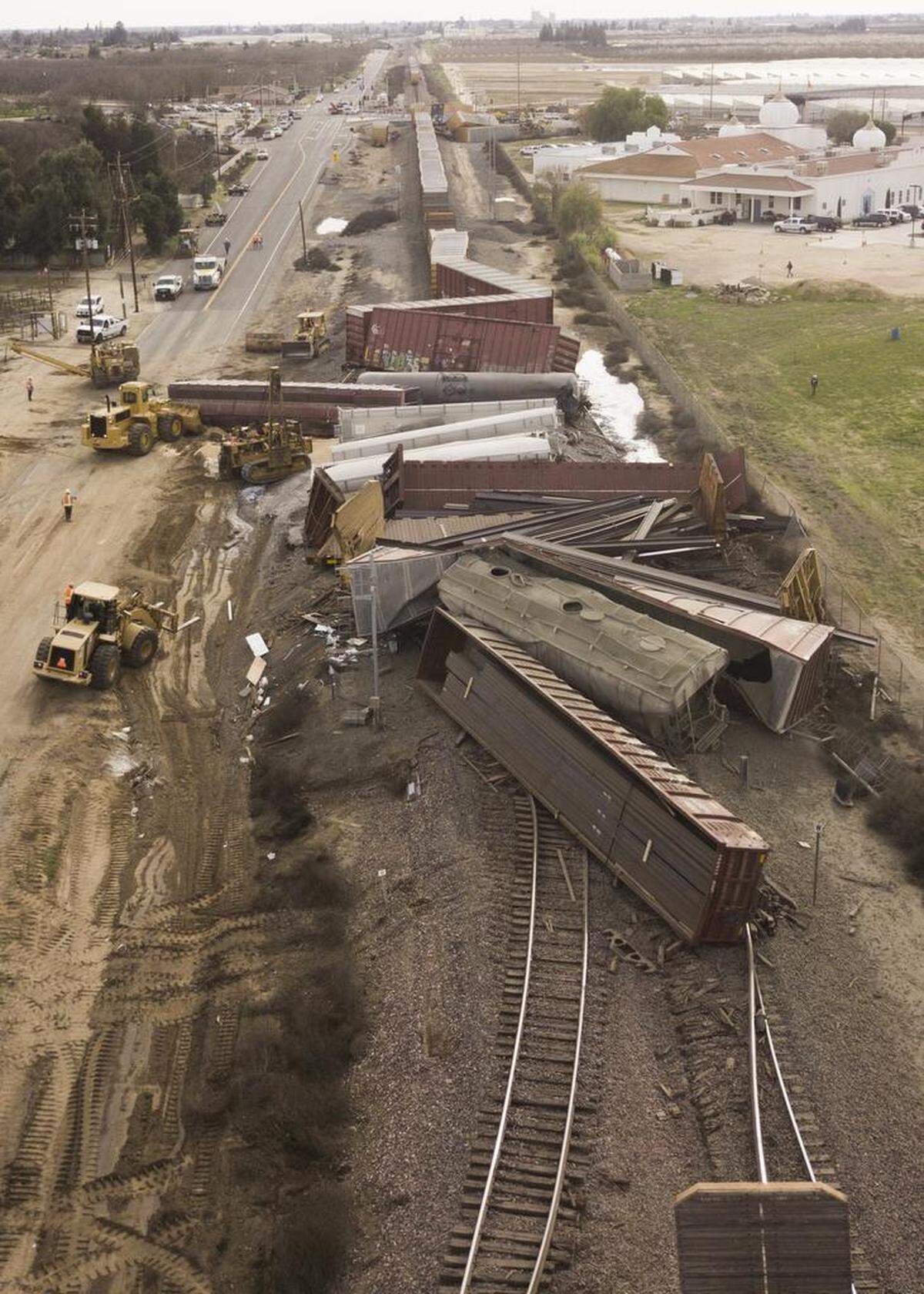 Crews work to clear and repair a section of Burlington Northern Santa Fe rail line north of Hatch Road and the town of Hughson, CA after a train derailment Sunday, Feb. 11, 2018.