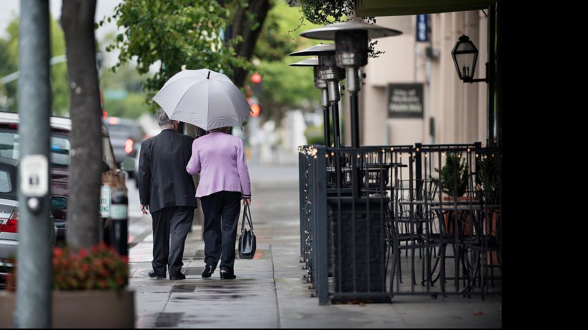 
Norman and Mollie Cavanna walk down 11th Street in Modesto on Thursday.

