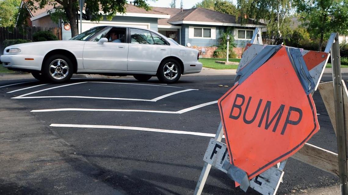 A motorist drives over a speed hump in Modesto in 2010.