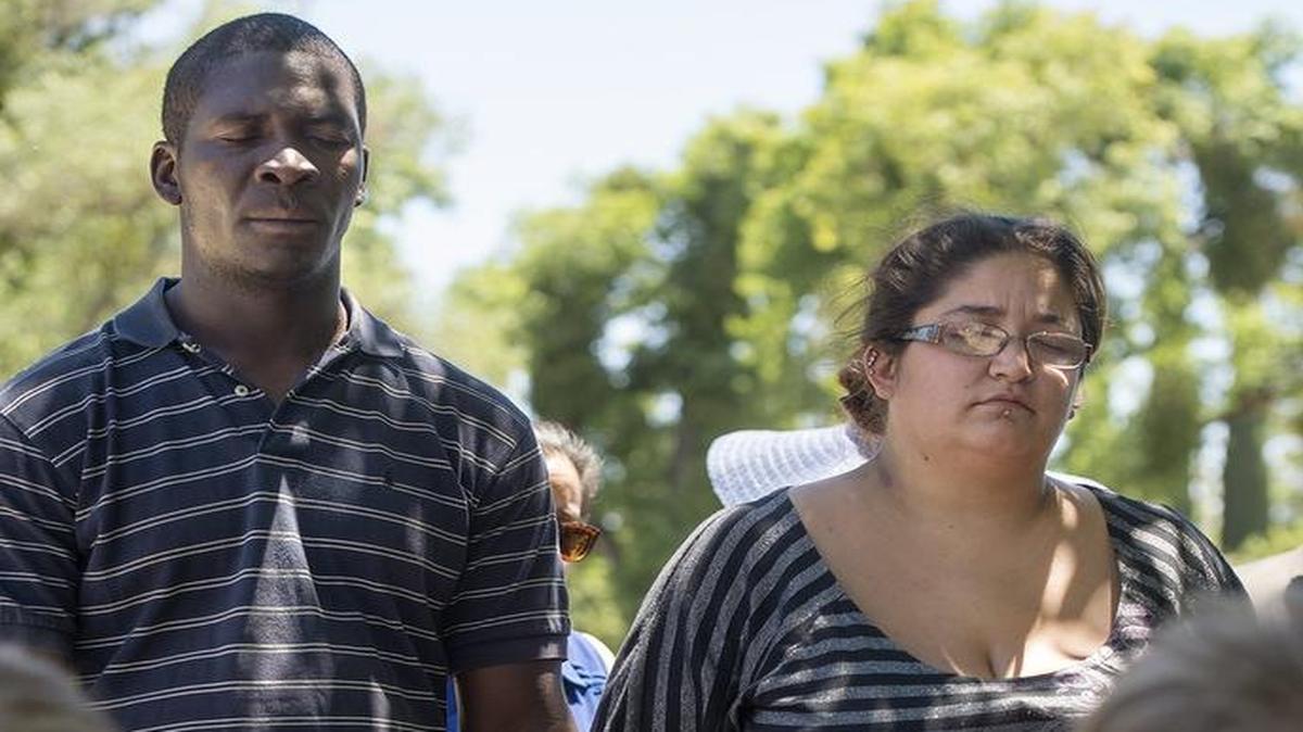 
Ibrahim Kamara, left, and Charlene Snyder pray with members of local congregations who gathered for a vigil at First Christian Methodist Episcopal church in Modesto on Sunday in memory of the people killed at the Emanuel AME Church in South Carolina.

