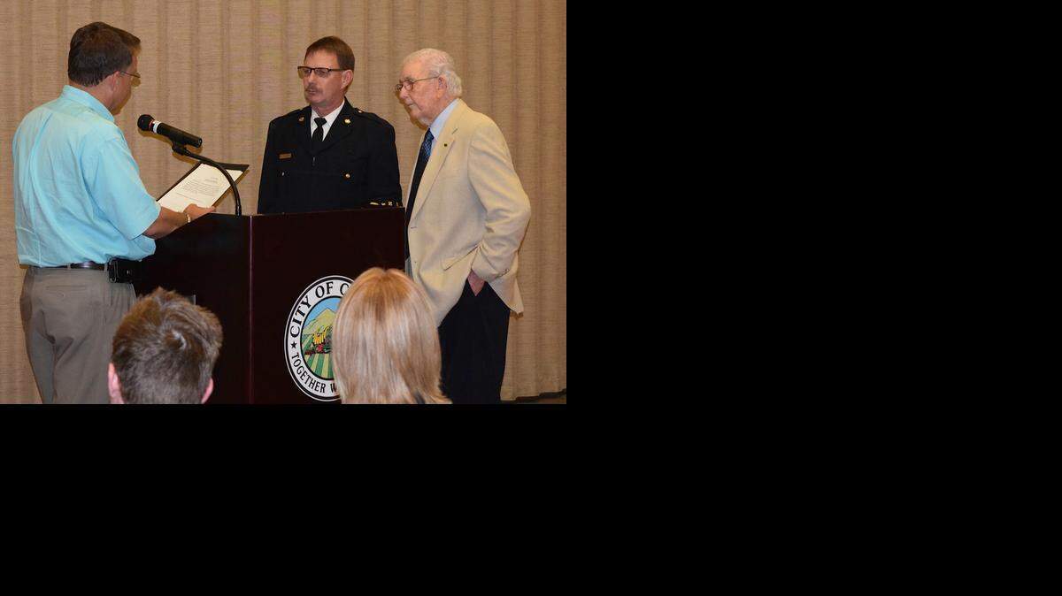 
Mayor Chris Vierra swears in fire Chief Bryan Nicholes alongside pastor Adrian Condit on Monday evening  at the Ceres Community Center.
