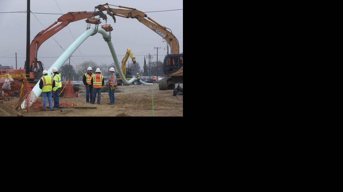 
Excavators with roller attachments help to guide the 18-inch-diameter fusible PVC sewer line that is being pulled from the other side of the river. This second sewer line is installed from the east side of Tuolumne River off Zeff Road, going below the river and coming up on the west side of the river near Dryden Golf Course.
